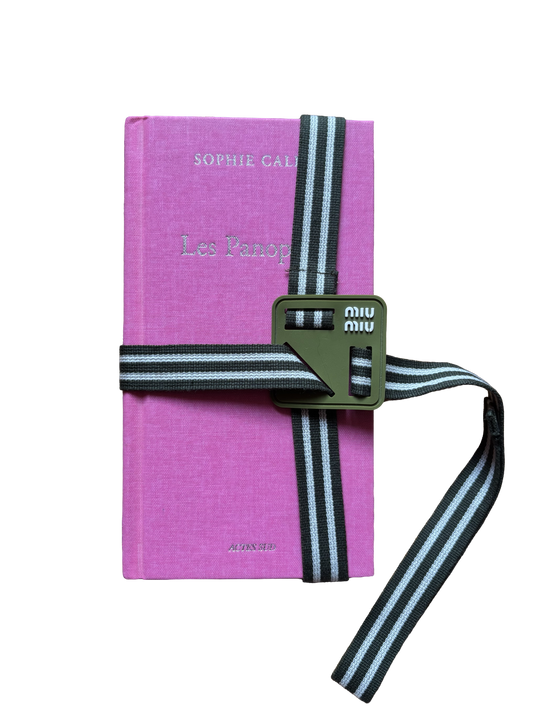 Miu Miu reads book strap